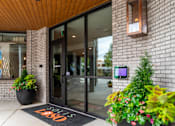 Thumbnail 37 of 47 - Building entrance with keypad access and welcome mat at The Yancey Apartments, Charlotte, NC
