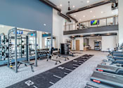 Thumbnail 38 of 47 - Two story fitness center with cardio and strength training equipment at The Yancey Apartments, North Carolina