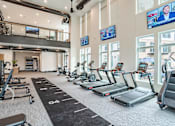 Thumbnail 36 of 47 - Spacious fitness center with treadmills and stationary bikes at The Yancey Apartments, Charlotte