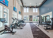 Thumbnail 42 of 47 - Fitness center with cardio machines and weight training area at The Yancey Apartments, North Carolina, 28217