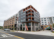 Thumbnail 46 of 47 - Modern apartment building exterior with corner balconies at The Yancey Apartments, Charlotte, NC 28217