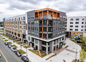 Thumbnail 30 of 47 - Modern apartment building exterior with street view at The Yancey Apartments, Charlotte, 28217