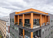 Thumbnail 32 of 47 - Rooftop amenity deck with covered pavilion and skyline views at The Yancey Apartments, Charlotte, NC