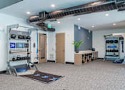 Thumbnail 29 of 47 - Functional training studio with equipment racks and wall storage at The Yancey Apartments, North Carolina