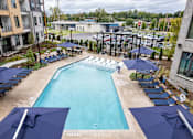 Thumbnail 24 of 47 - Outdoor pool with tanning ledge and cabana seating at The Yancey Apartments, North Carolina, 28217