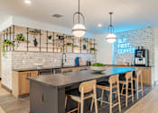 Thumbnail 31 of 47 - Community kitchen with island seating and coffee bar at The Yancey Apartments, Charlotte, North Carolina
