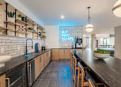 Thumbnail 20 of 47 - Coffee bar with subway tile and wood shelving at The Yancey Apartments, Charlotte