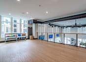 Thumbnail 19 of 47 - Upper level fitness area with cable railing and exposed ductwork at The Yancey Apartments, North Carolina