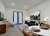 Thumbnail 19 of 30 - A modern living room with a green couch and a coffee table at Vintage Edge Nashville Apartments, Tennessee
