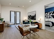 Thumbnail 21 of 30 - A modern living room with a dining table and chairs at Vintage Edge Nashville Apartments, Nashville, Tennessee