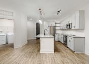 Thumbnail 27 of 30 - A kitchen with white appliances and cabinets at Vintage Edge Nashville Apartments, Nashville, TN, 37211