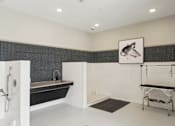 Thumbnail 37 of 41 - A bathroom with a black and white theme, featuring a bathtub, a shower, and a gym setup at Vintage Raleigh West Apartments, North Carolina