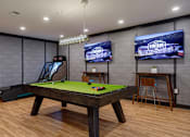 Thumbnail 5 of 30 - A room with a pool table and a TV screen showing the word "VINTAGE".