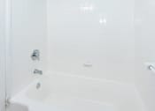 Thumbnail 4 of 10 - a bathroom with a white bathtub and a blue ceiling