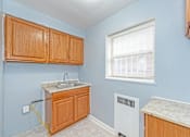 Thumbnail 2 of 10 - a kitchen with wood cabinets and a sink