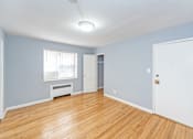 Thumbnail 8 of 10 - a bedroom with hardwood floors and blue walls