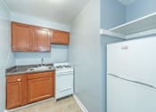 Thumbnail 1 of 10 - a kitchen with a white refrigerator freezer next to a stove top oven