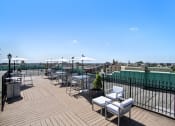 Thumbnail 21 of 30 - a rooftop terrace with tables and chairs and a view of the city