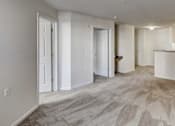 Thumbnail 1 of 11 - the living room and kitchen of an empty apartment at Windsor Crossing Senior, Suitland 