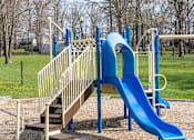 Thumbnail 10 of 10 - A playground with a blue slide and a wooden staircase at Dutch Village Apartments, Baltimore, MD, 21234