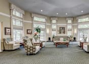 Thumbnail 5 of 11 - a large living room filled with furniture and large windows at Windsor Crossing Senior, Suitland, MD 
