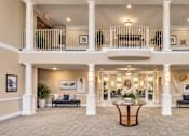 Thumbnail 1 of 29 - A large, open-concept living space with a balcony and a central seating area.