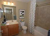 Thumbnail 8 of 10 - A bathroom with a toilet, sink, and shower at Argent Apartments, Silver Spring, 20910