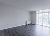 Thumbnail 25 of 29 - A room with wooden floors and a window with blinds at Charlestowne North Apartments, Greenbelt, MD