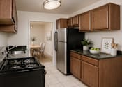 Thumbnail 9 of 17 - A kitchen with a black stove and a black refrigerator.