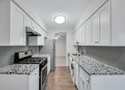 Thumbnail 18 of 49 - Kitchen with refrigerator and white cabinets at Columbia Pointe, Columbia, MD