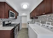 Thumbnail 15 of 49 - Kitchen With White Cabinetry And Appliances at Columbia Pointe, Columbia