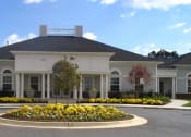 Thumbnail 5 of 9 - a large white house with yellow flowers in front of it at Overland Gardens, Landover, MD 
