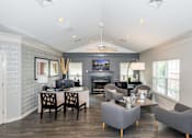 Thumbnail 29 of 32 - leasing office with hardwood floors, chairs, desk, and TV at Governors Green, Bowie