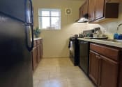 Thumbnail 4 of 10 - a kitchen with stainless steel appliances and wooden cabinets