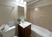 Thumbnail 6 of 10 - a bathroom with a sink and a toilet and a bath tub