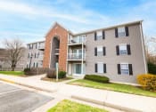 Thumbnail 2 of 16 - a picture of an apartment building with a sidewalk in front of it