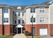 Thumbnail 7 of 9 - a row of town houses with a sidewalk in front of them at Overland Gardens, Landover 