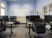 Thumbnail 9 of 9 - a classroom with computers and desks and a whiteboard at Overland Gardens, Landover, MD 