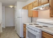 Thumbnail 1 of 9 - a kitchen with a stove refrigerator and sink at Overland Gardens, Maryland 