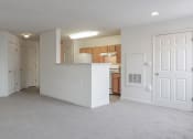 Thumbnail 2 of 9 - an empty living room and a kitchen with a counter at Overland Gardens, Landover, MD 20785 