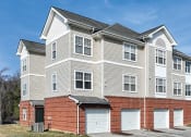 Thumbnail 8 of 9 - a row of town houses with garage doors at Overland Gardens, Maryland, 20785