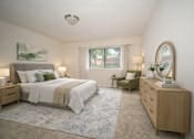 Thumbnail 3 of 19 - A bedroom with a large bed, a chair, and a dresser.