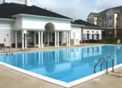 Thumbnail 6 of 9 - a large swimming pool in front of a building at Overland Gardens, Landover Maryland 