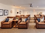 Thumbnail 8 of 29 - A room with brown leather chairs and pillows.