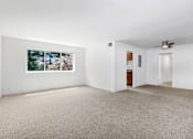 Thumbnail 12 of 19 - A room with a carpeted floor and a ceiling fan.