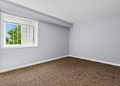 Thumbnail 2 of 6 - an empty room with a window and a carpet