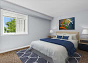 Thumbnail 9 of 14 - a bedroom with a bed and two nightstands