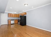 Thumbnail 6 of 6 - a kitchen with wood floors and wooden cabinets