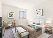 Thumbnail 6 of 46 - A bedroom with a large bed, a chair, and a TV at Seven Springs Apartments, College Park
