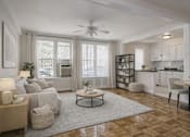 Thumbnail 5 of 18 - A living room with a white couch, a coffee table, and a ceiling fan.